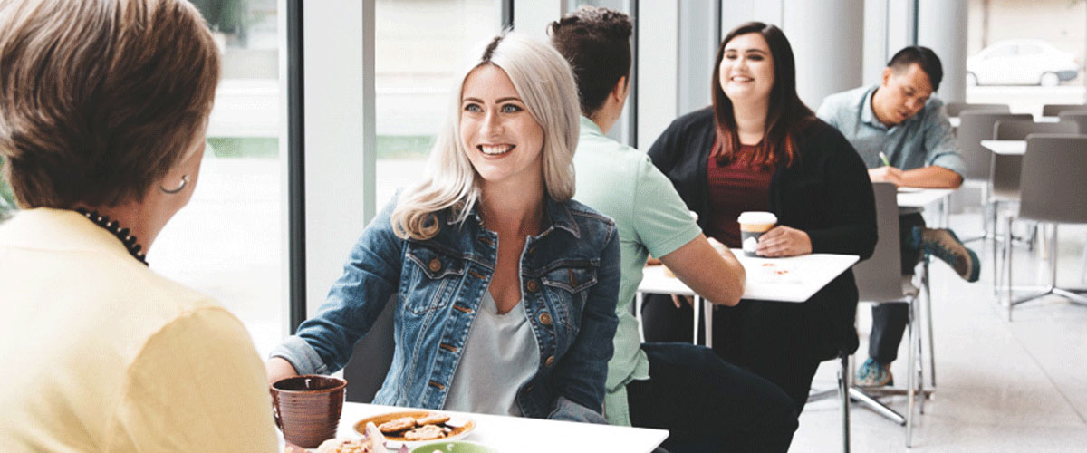 Photo of people eating together in the Café