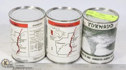 Three cans of "tornado dust" with labels sharing statistics of the 1987 Black Friday tornado