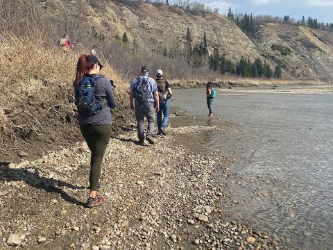Members of Quaternary Palaeontology walk along the river bank.