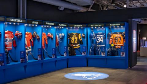 Blue cabinets show seven hockey jerseys from star players in the NHL