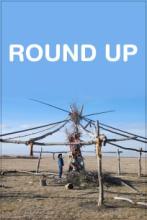 A person looking up at the skeleton framing of a tent the words Round Up are over the tent frame